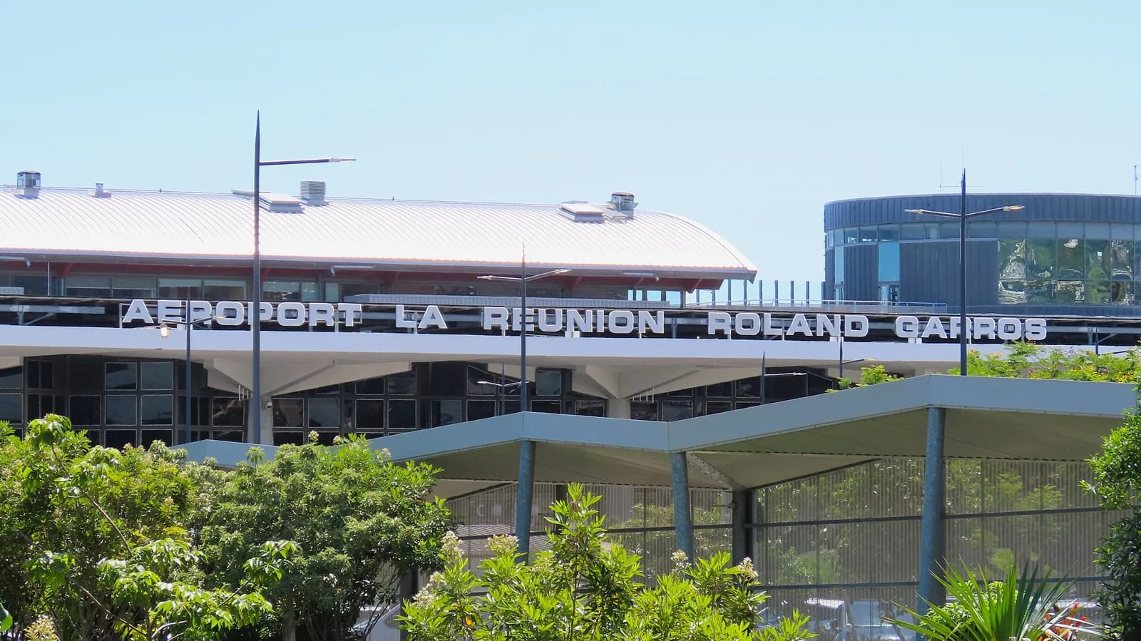 Façade du terminal de l'aéroport La Réunion Roland Garros à Sainte-Marie, avec son enseigne